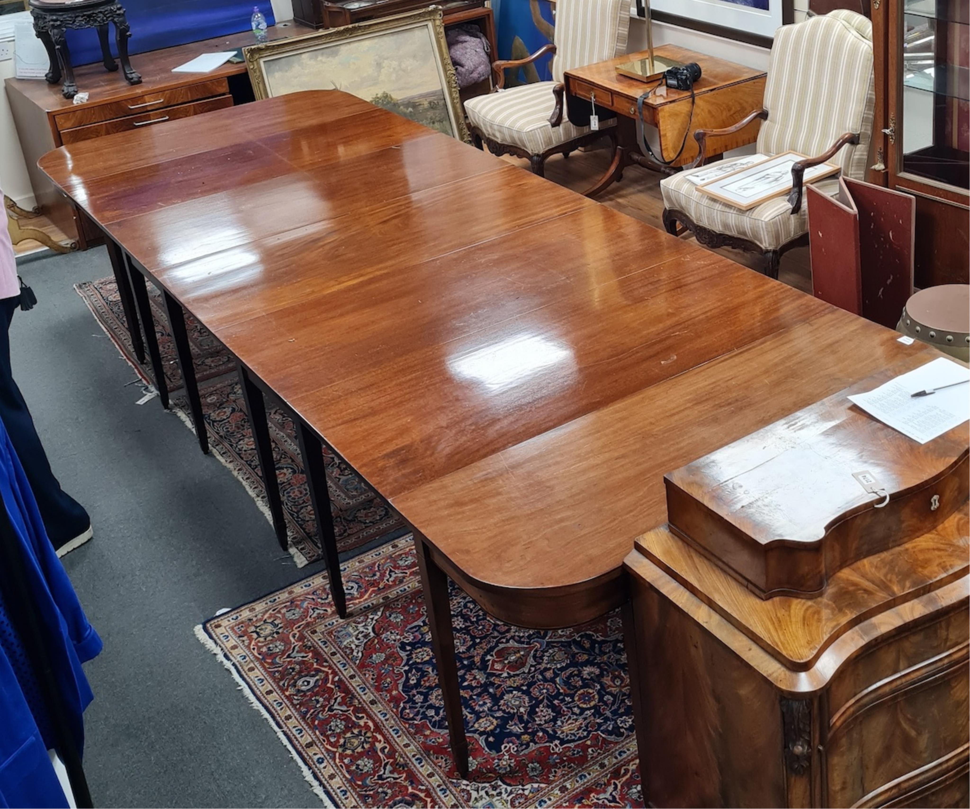 A George III mahogany extending dining table, width 396cm extended, depth 137cm, height 74cm. Condition - fair
